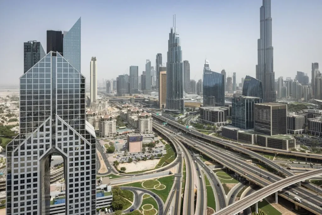 Sheikh Zayed Road Dubai with Emirates Towers and Burj Khalifa skyline — benefits of buying property in Dubai for Indian investors