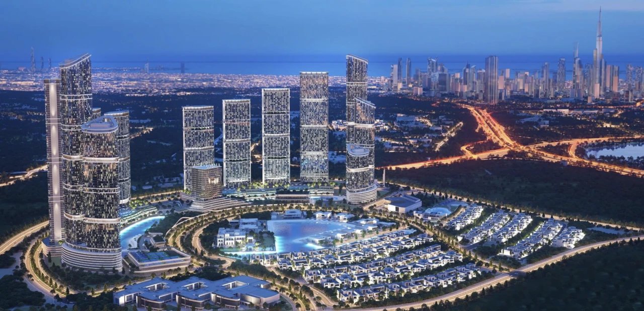 Large Dubai master-planned off-plan community at night with Burj Khalifa skyline — risks of buying property in Dubai for Indian investors