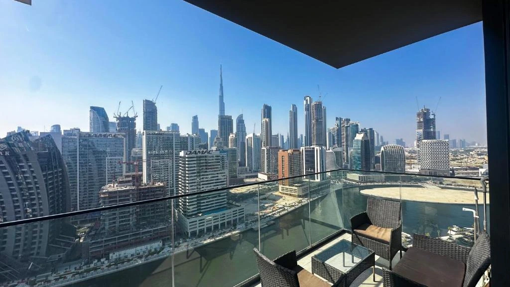 Emaar luxury residential courtyard pool with Burj Khalifa framed between two towers — risks of buying property in Dubai