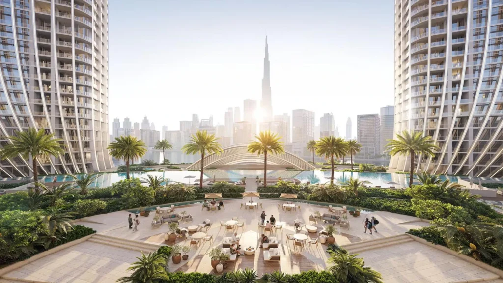 Large Dubai master-planned off-plan community at night with Burj Khalifa skyline — risks of buying property in Dubai for Indian investors