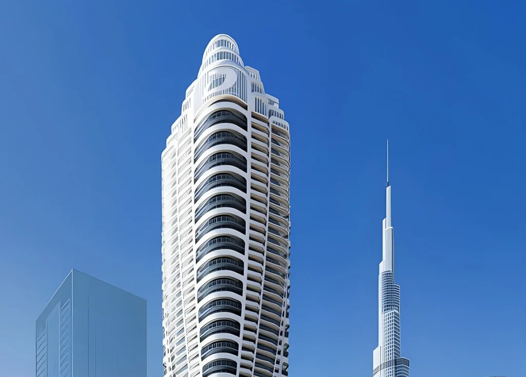 A ground-level photograph of Dubai Marina's signature tower cluster featuring Princess Tower, Cayan Tower, DAMAC Heights, and Marriott Harbour Hotel against a daytime sky. Dubai Marina is one of the most active freehold zones for Indian buyers — properties here attract premium tenants and consistent rental demand, all within a market where property tax in Dubai is zero, rental income tax is zero, and capital gains tax on resale does not apply