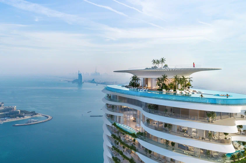 Six Senses Residences Palm Jumeirah rooftop infinity pool with Burj Al Arab view — benefits of buying property in Dubai for Indian investors